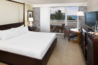 A delightfully appointed Island-inspired guest room with beautiful views of the Caribbean
